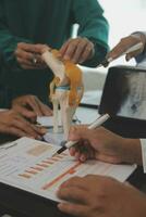 Group of doctors reading a document in meeting room at hospital photo