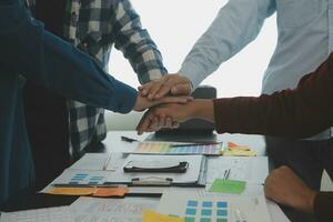 Close up ux developer and ui designer brainstorming about mobile app interface wireframe design on table with customer breif and color code at modern office.Creative digital development agency photo