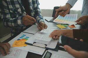 Close up ux developer and ui designer brainstorming about mobile app interface wireframe design on table with customer breif and color code at modern office.Creative digital development agency photo