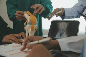 Group of doctors reading a document in meeting room at hospital photo