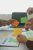 Close up ux developer and ui designer brainstorming about mobile app interface wireframe design on table with customer breif and color code at modern office.Creative digital development agency photo