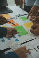 Close up ux developer and ui designer brainstorming about mobile app interface wireframe design on table with customer breif and color code at modern office.Creative digital development agency photo