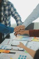 Close up ux developer and ui designer brainstorming about mobile app interface wireframe design on table with customer breif and color code at modern office.Creative digital development agency photo