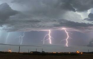 Thick black clouds flashed lightning in the sky photo