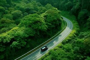 Road winds through the lush forest with modern cars driving through the trees.Generative Ai. photo