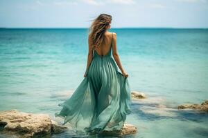 Beautiful woman in dress standing on rock with beautiful sea background.Generative Ai. photo