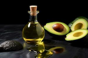Avocado oil with fresh avocado on black stone background photo
