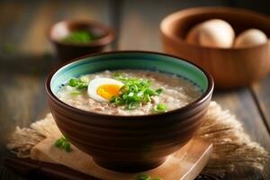 Porridge rice gruel with boiled eggs in bowl on table photo