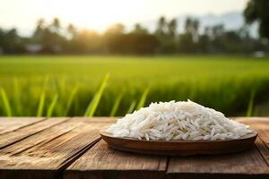 White rice on wooden with the rice field background photo