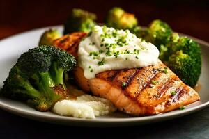 Grilled salmon with mashed potatoes and broccoli photo