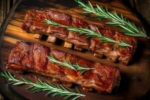 Fresh grilled pork with rosemary on a wooden background photo