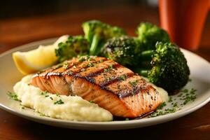 Grilled salmon with mashed potatoes and broccoli photo
