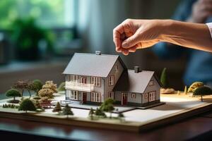 A couple on a desk with a house model and house keys photo