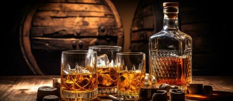 Whiskey glasses, bottles and barrels photo