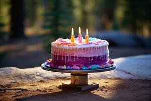 birthday cake on wooden table with candles in garden. photo