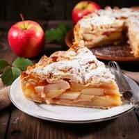 apple pie lies on a white plate on a wooden table. photo