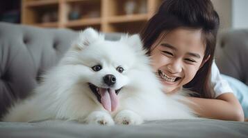 a girl  plays with white fluffy photo