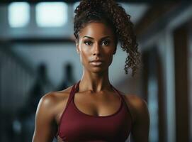 Young beautiful afro american beauty exercising in gym photo