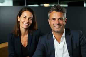 Business couple smiling in an office photo