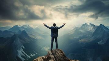 A business person standing on top of a mountain photo