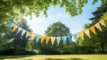 Colorful bunting at the party with trees behind it photo