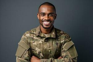 A young black man in a military uniform is smiling and posing for a photo