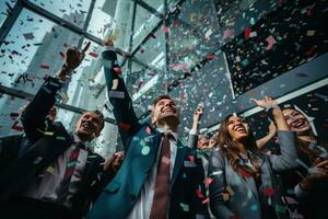Business people with confetti in the air celebrating success at work photo