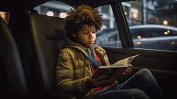 Little boy reading a magazine in a car photo