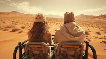 A young couple rides in a buggy through the desert in the UAE photo