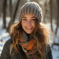 Woman with scarf and hat in snowy forest photo