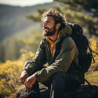 Backpacker taking a break on mountain trail photo