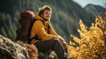 Backpacker taking a break on mountain trail photo