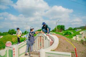 Chonburi, Thailand, 9, April, 2018 Chinese descendants cleaning tomb and offering prayers to ancestors during in Qingming Festival ,Tomb-Sweeping Day photo