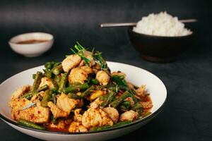 Close up, Tasty Stir-fried pork and red hot curry paste with or long bean and Ingredients are oyster sauce, fish sauce, sugar, kaffir lime leaves in the dish Eat with cooked rice. Thai food photo