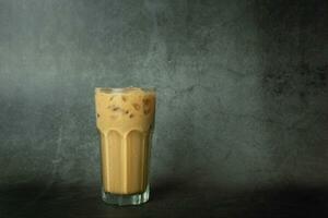 Iced of coffee cup on glass cup  on black background. Copy space your text photo