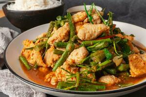 Close up, Stir-fried pork and red hot curry paste with or long bean and Ingredients are oyster sauce, fish sauce, sugar, kaffir lime leaves in the dish Eat with cooked rice. Thai cuisine photo