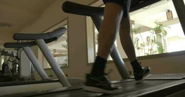 Stepping on treadmill in the gym video