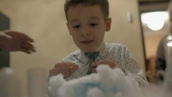 Boy watching reaction of mixing dry ice and liquid nitrogen Fun with chemistry video