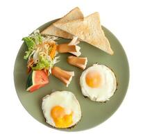 Close up photo of American breakfast top view in dark green plate isolated on white background with clipping path