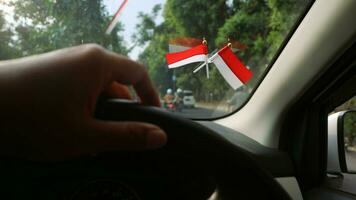 The Indonesian flag is mounted on the windshield of the car to welcome Indonesia's independence day photo