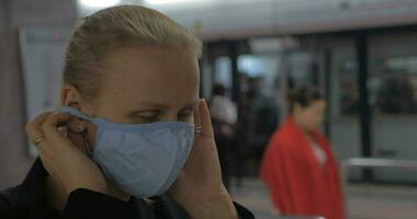 In Hong Kong, China in subway a young girl wears a medical mask video