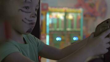 A boy in a painted face playing on a game machine video