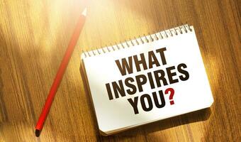 WHAT INSPIRES YOU words on notebook with red pencil photo
