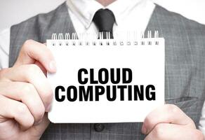 Businessman with notebook with text CLOUD COMPUTING photo