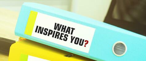 Two office folders with text WHAT INSPIRES YOU photo