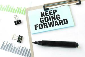 Paper plate, marker, diagram, chart and office tools. Text KEEP GOING FORWARD photo