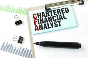 Paper plate, marker, diagram, chart and office tools. Text CHARTERED FINANCIAL ANALYST photo