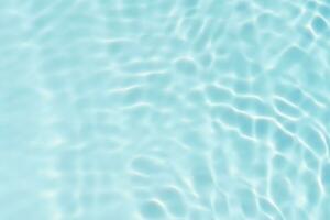 Blue water with ripples on the surface. Defocus blurred transparent blue colored clear calm water surface texture with splashes and bubbles. Water waves with shining pattern texture background. photo