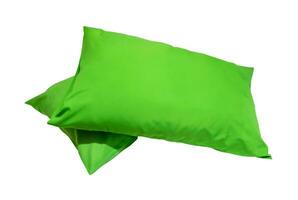 Green pillows in stack in hotel or resort room isolated on white background with clipping path. Concept of comfortable and happy sleep in daily life photo