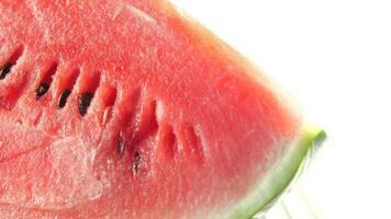 close up of slice of water melon on white background . video